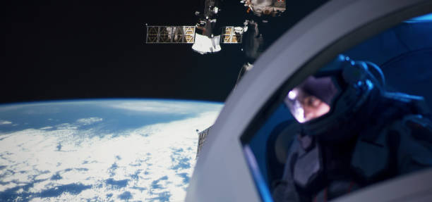 istock Astronaut looking out of spaceship window 1199867017