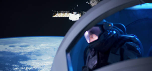 istock Astronaut looking out of spaceship window 1199867032