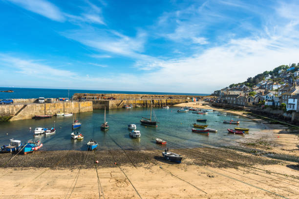 istock Small fishing boats in Mousehole harbour 1199867166