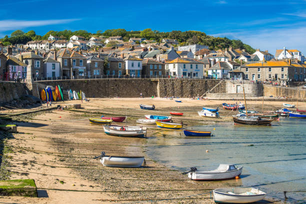 istock Small fishing boats in Mousehole harbour 1199867267