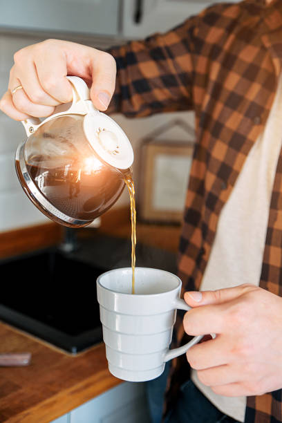 istock Caucasian man pours coffee in a cup 1199867365