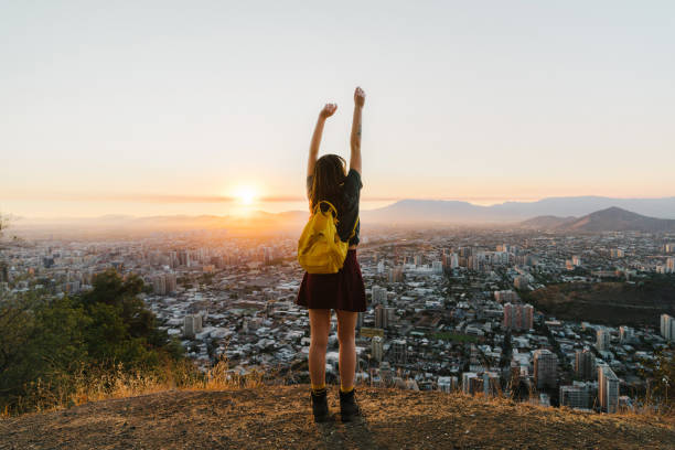 Young Caucasian woman with yellow backpack in Santiago at sunset, Chile