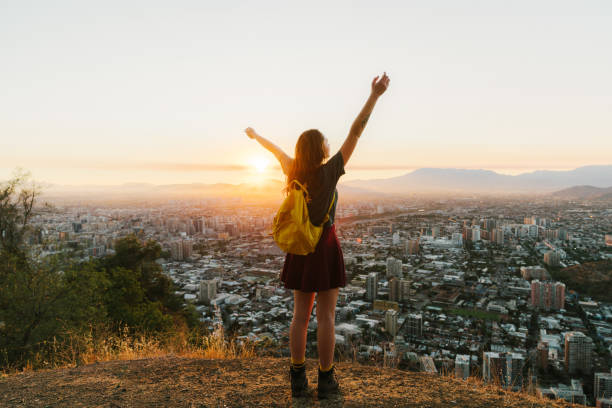 Woman in Santiago at sunset Young Caucasian woman with yellow backpack in Santiago at sunset, Chile santiago chile photos stock pictures, royalty-free photos & images