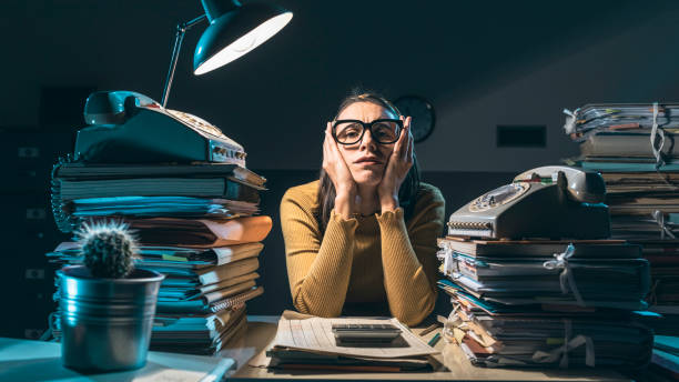 istock Exhausted businesswoman working late at night 1199868767