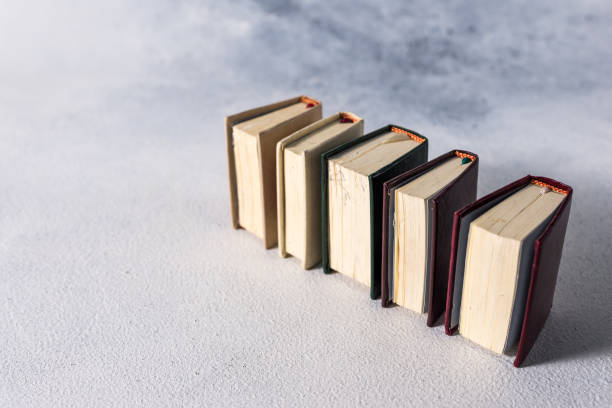 istock A stack of old little books. Shabby pages, damaged book covers 1199870231