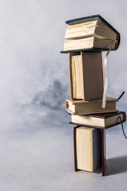 istock A stack of old little books. Shabby pages, damaged book covers 1199870233