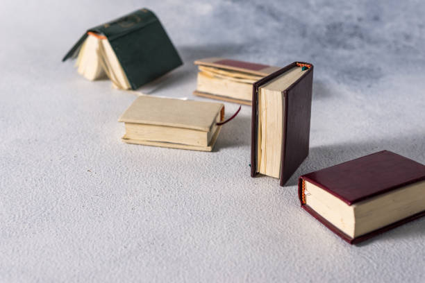 istock A stack of old little books. Shabby pages, damaged book covers 1199870246