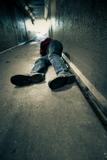 istock Homeless man sleeping rough in cold subway tunnel 1199875841