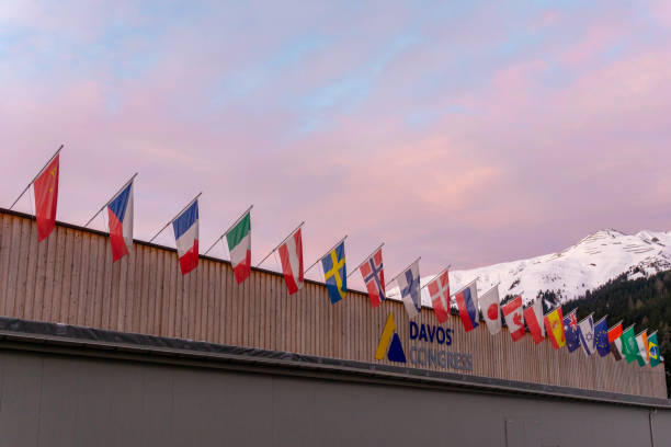 the congress center in Davos with flags of nations at sunrise during the WEF World Economic Forum Davos, GR / Switzerland - 14 January 2020: the congress center in Davos with flags of nations at sunrise during the WEF World Economic Forum graubunden canton photos stock pictures, royalty-free photos & images