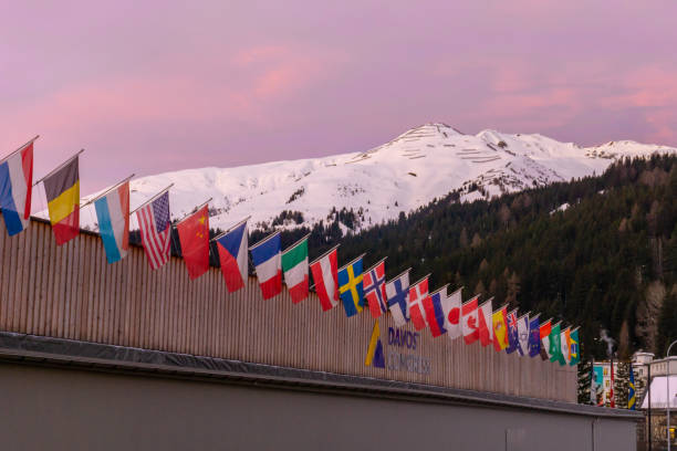 the congress center in Davos with flags of nations at sunrise during the WEF World Economic Forum Davos, GR / Switzerland - 14 January 2020: the congress center in Davos with flags of nations at sunrise during the WEF World Economic Forum graubunden canton photos stock pictures, royalty-free photos & images
