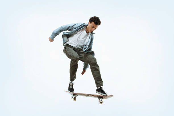 istock Caucasian young skateboarder riding isolated on a white background 1199878232