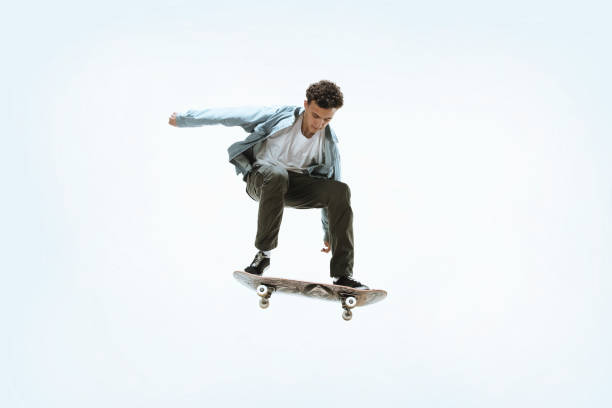istock Caucasian young skateboarder riding isolated on a white background 1199878234