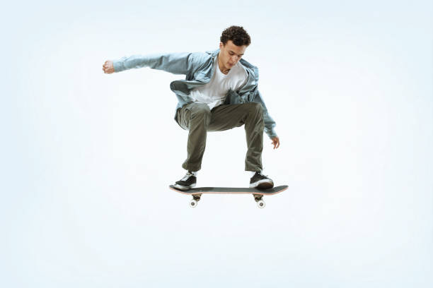 istock Caucasian young skateboarder riding isolated on a white background 1199878236