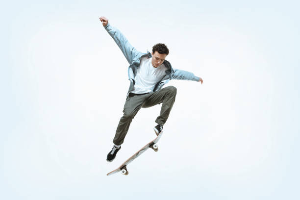 istock Caucasian young skateboarder riding isolated on a white background 1199878239