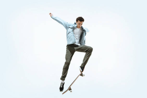 istock Caucasian young skateboarder riding isolated on a white background 1199878241