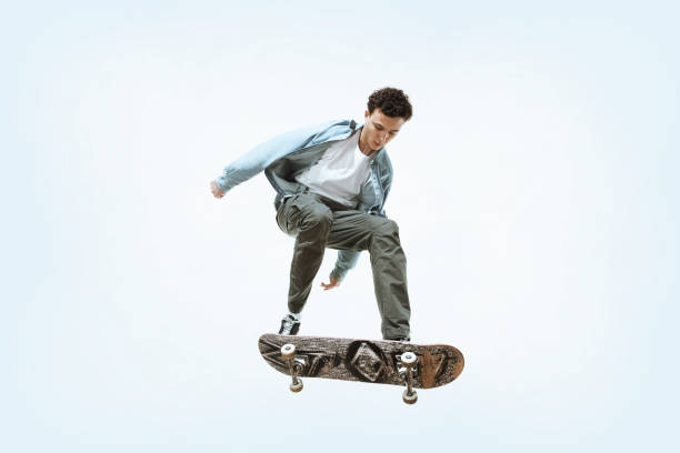 istock Caucasian young skateboarder riding isolated on a white background 1199878243