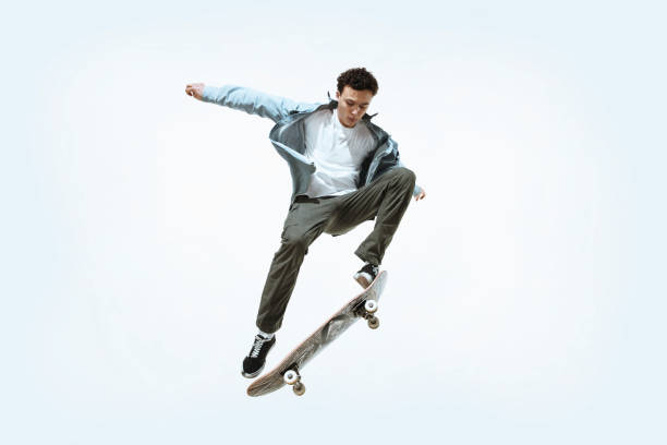 istock Caucasian young skateboarder riding isolated on a white background 1199878246