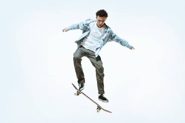 istock Caucasian young skateboarder riding isolated on a white background 1199878247