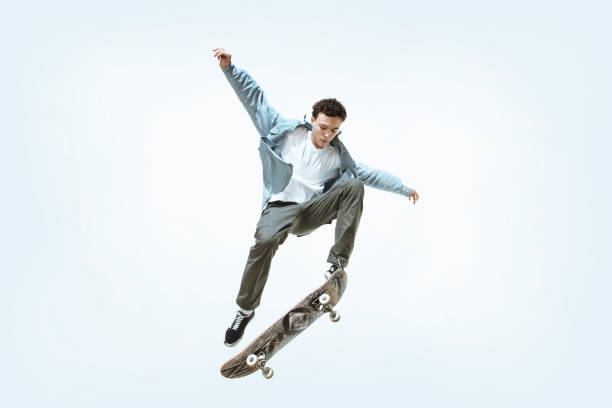 istock Caucasian young skateboarder riding isolated on a white background 1199878249