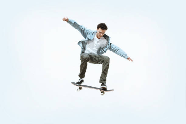 istock Caucasian young skateboarder riding isolated on a white background 1199878255