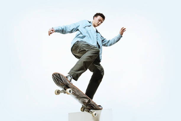 istock Caucasian young skateboarder riding isolated on a white background 1199878257