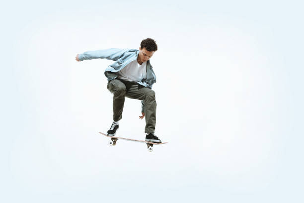 istock Caucasian young skateboarder riding isolated on a white background 1199878258