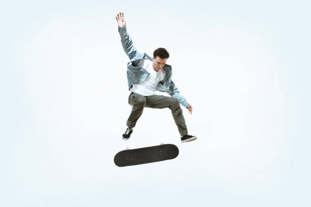 istock Caucasian young skateboarder riding isolated on a white background 1199878260