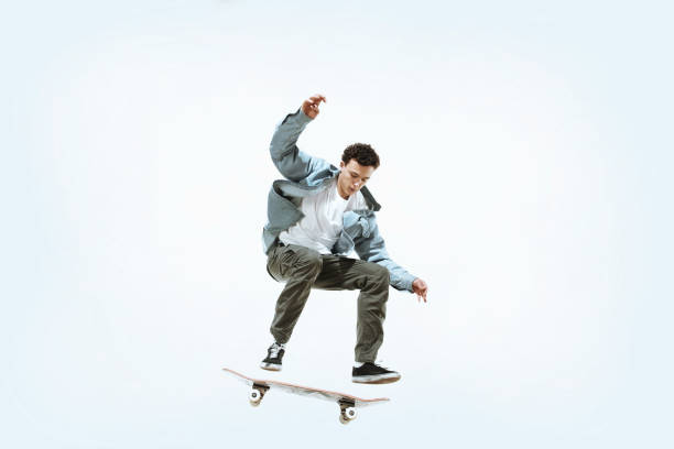 istock Caucasian young skateboarder riding isolated on a white background 1199878267
