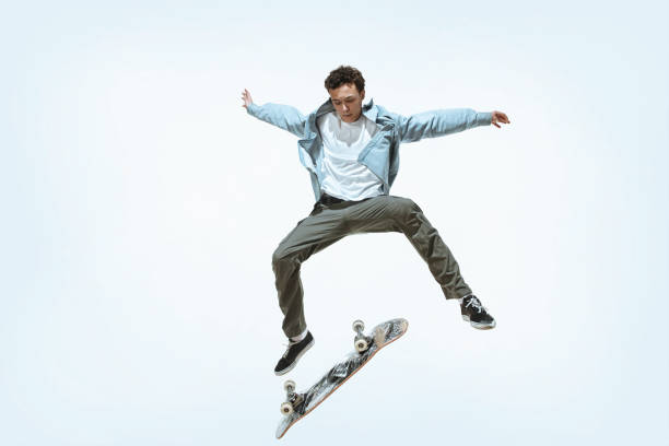istock Caucasian young skateboarder riding isolated on a white background 1199878274
