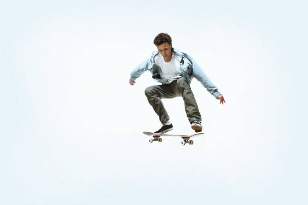 istock Caucasian young skateboarder riding isolated on a white background 1199878281