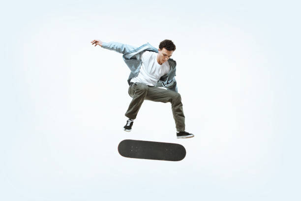 istock Caucasian young skateboarder riding isolated on a white background 1199878282