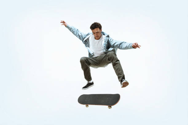 istock Caucasian young skateboarder riding isolated on a white background 1199878283