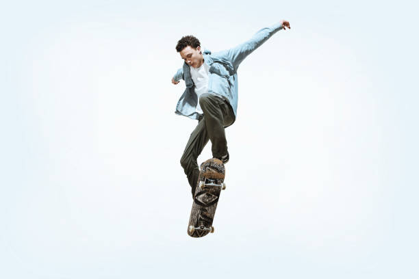 istock Caucasian young skateboarder riding isolated on a white background 1199878287