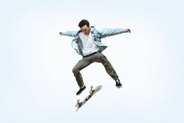 istock Caucasian young skateboarder riding isolated on a white background 1199878295