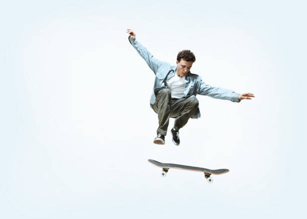 istock Caucasian young skateboarder riding isolated on a white background 1199878302