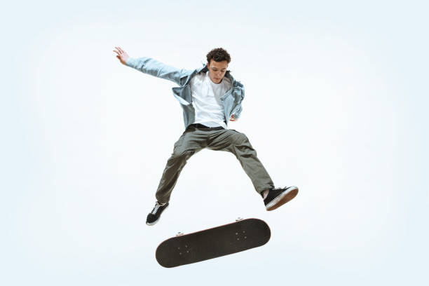 istock Caucasian young skateboarder riding isolated on a white background 1199878303