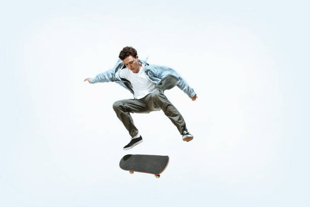 istock Caucasian young skateboarder riding isolated on a white background 1199878305