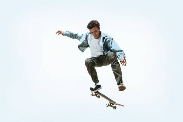 istock Caucasian young skateboarder riding isolated on a white background 1199878306