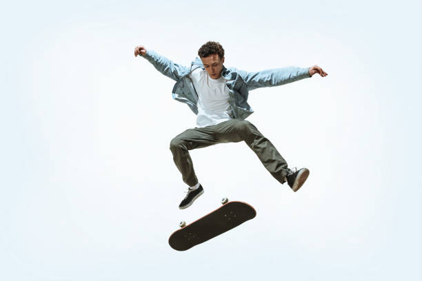 istock Caucasian young skateboarder riding isolated on a white background 1199878312