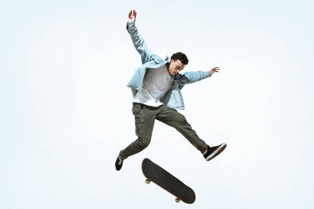 istock Caucasian young skateboarder riding isolated on a white background 1199878314