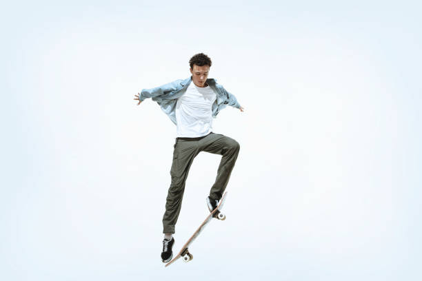 istock Caucasian young skateboarder riding isolated on a white background 1199878319