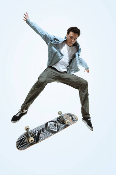istock Caucasian young skateboarder riding isolated on a white background 1199878328