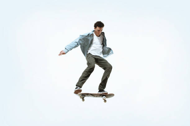 istock Caucasian young skateboarder riding isolated on a white background 1199878334