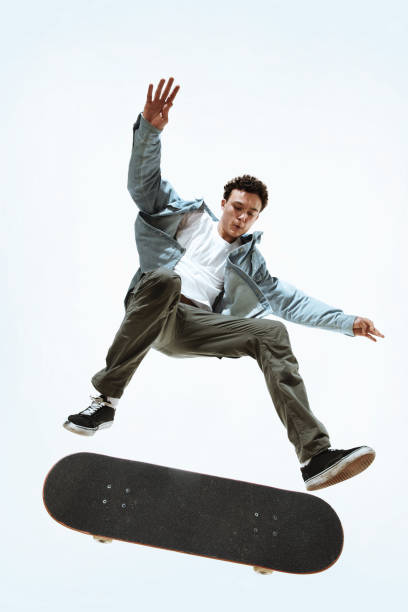 istock Caucasian young skateboarder riding isolated on a white background 1199878338