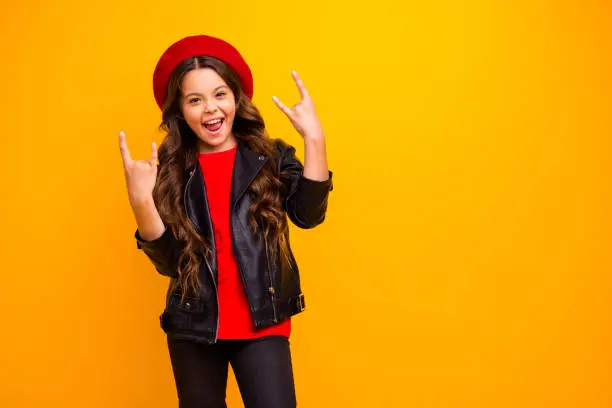 Portrait of her she nice attractive lovely cool crazy cheerful cheery long-haired girl wearing, streetstyle showing horn symbols isolated over bright vivid shine vibrant yellow color background