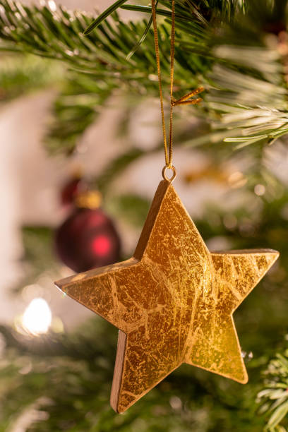 istock A golden star as decoration on a christmas tree 1199879917