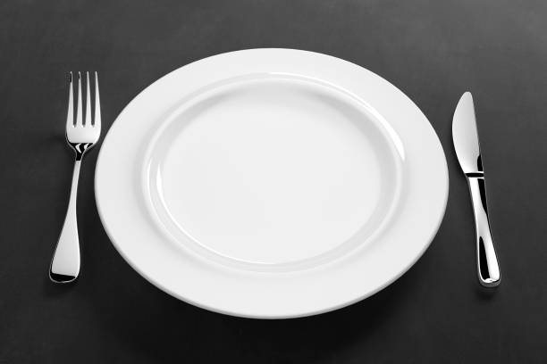 istock abstract white porcelain dinnerware with silver cutlery on table 1199882570