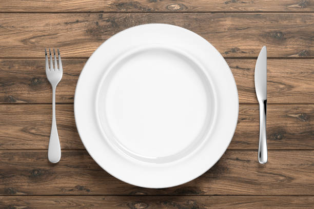istock abstract white porcelain dinnerware with silver cutlery on table 1199882600