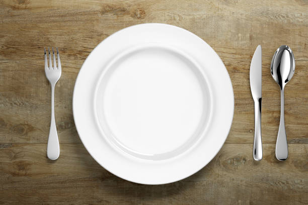 istock abstract white porcelain dinnerware with silver cutlery on table 1199882623