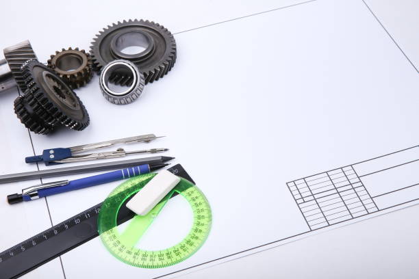 istock backdrop with drafting accessories, drafting paper and metal gears with copy space 1199883010